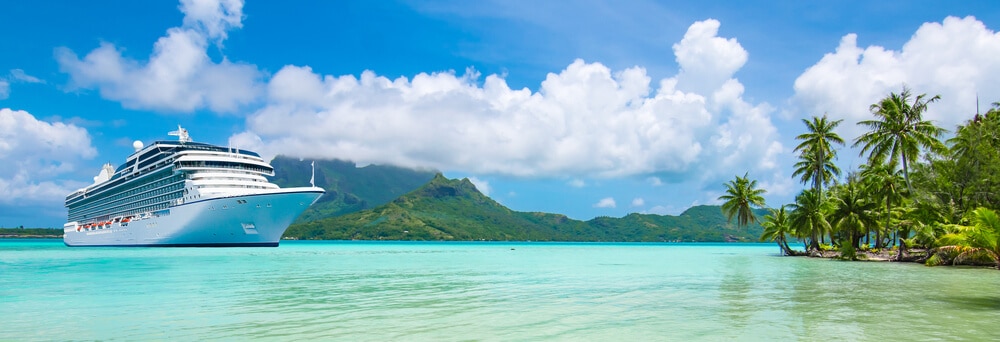 A cruise ship in a tropical paradise, representing a popular live auction item